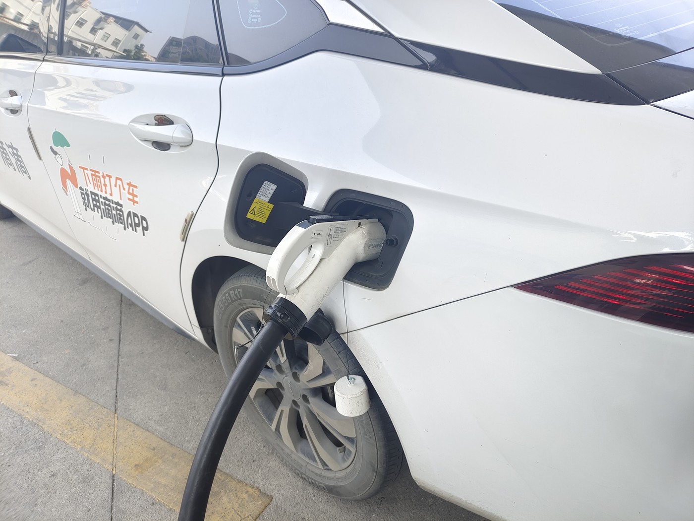 Close field view of a DC charging connector attached to an electric vehicle