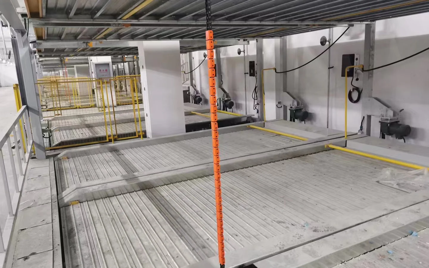 AC charging units and cable routes within a mechanical parking structure