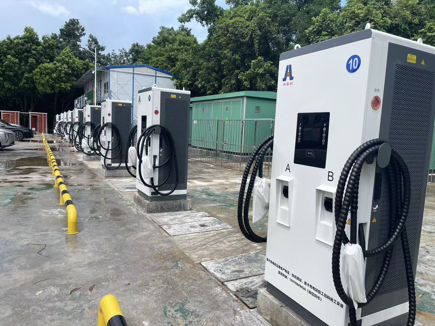 Row of installed Hongjiali charging cabinets with paired cables, A/B output markings and protective bollards